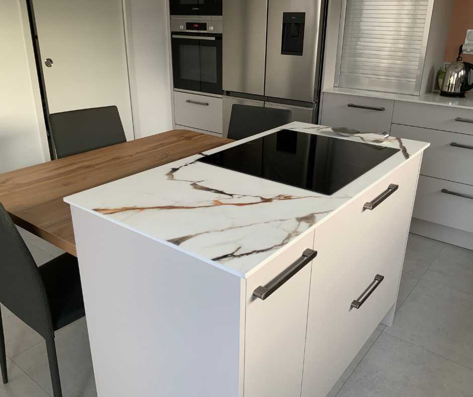 Cuisine sur mesure avec avec îlot en céramique et table en stratifié